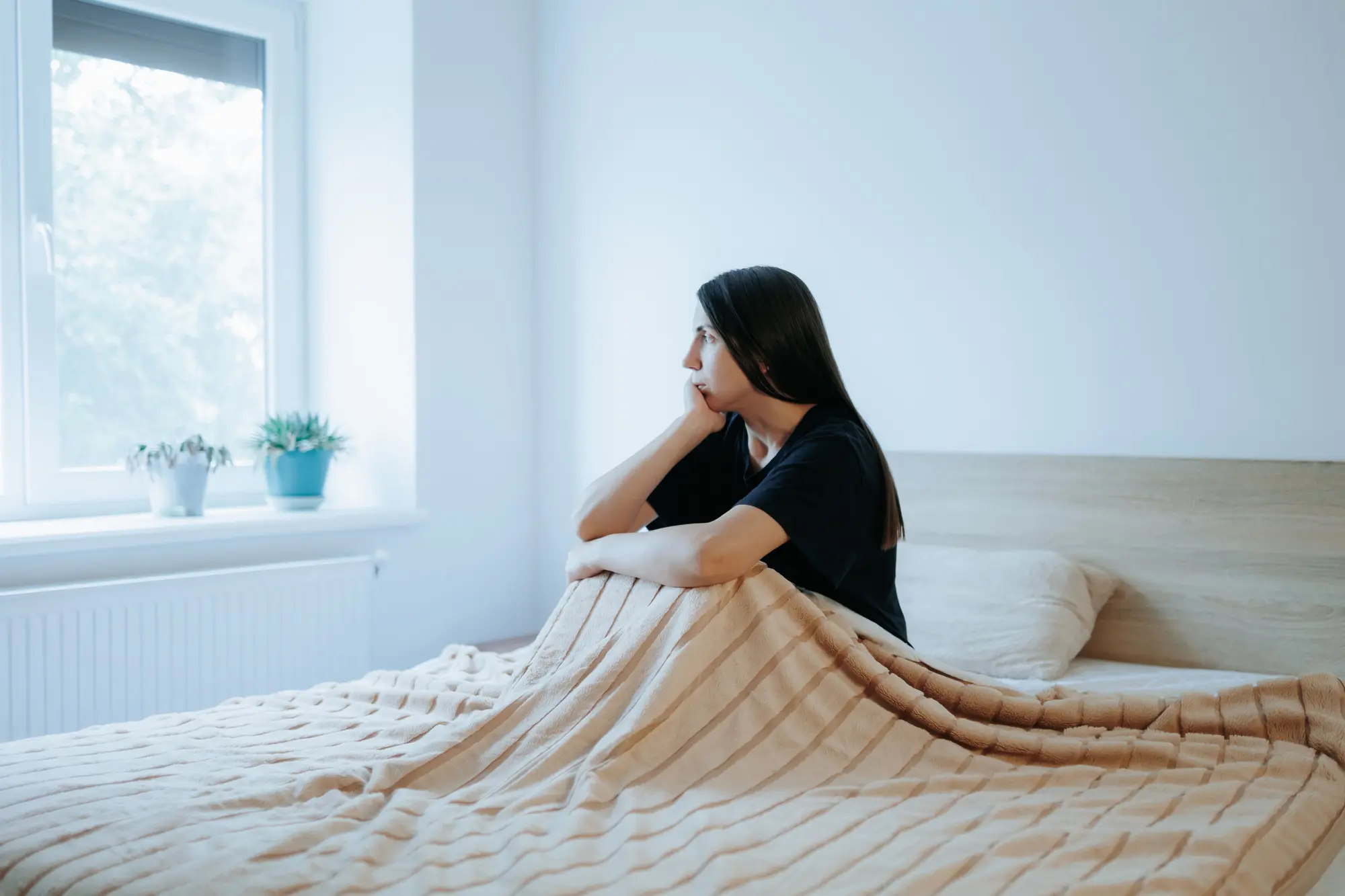 cognitive behavioral treatment therapy header with woman sitting in a bright bedroom